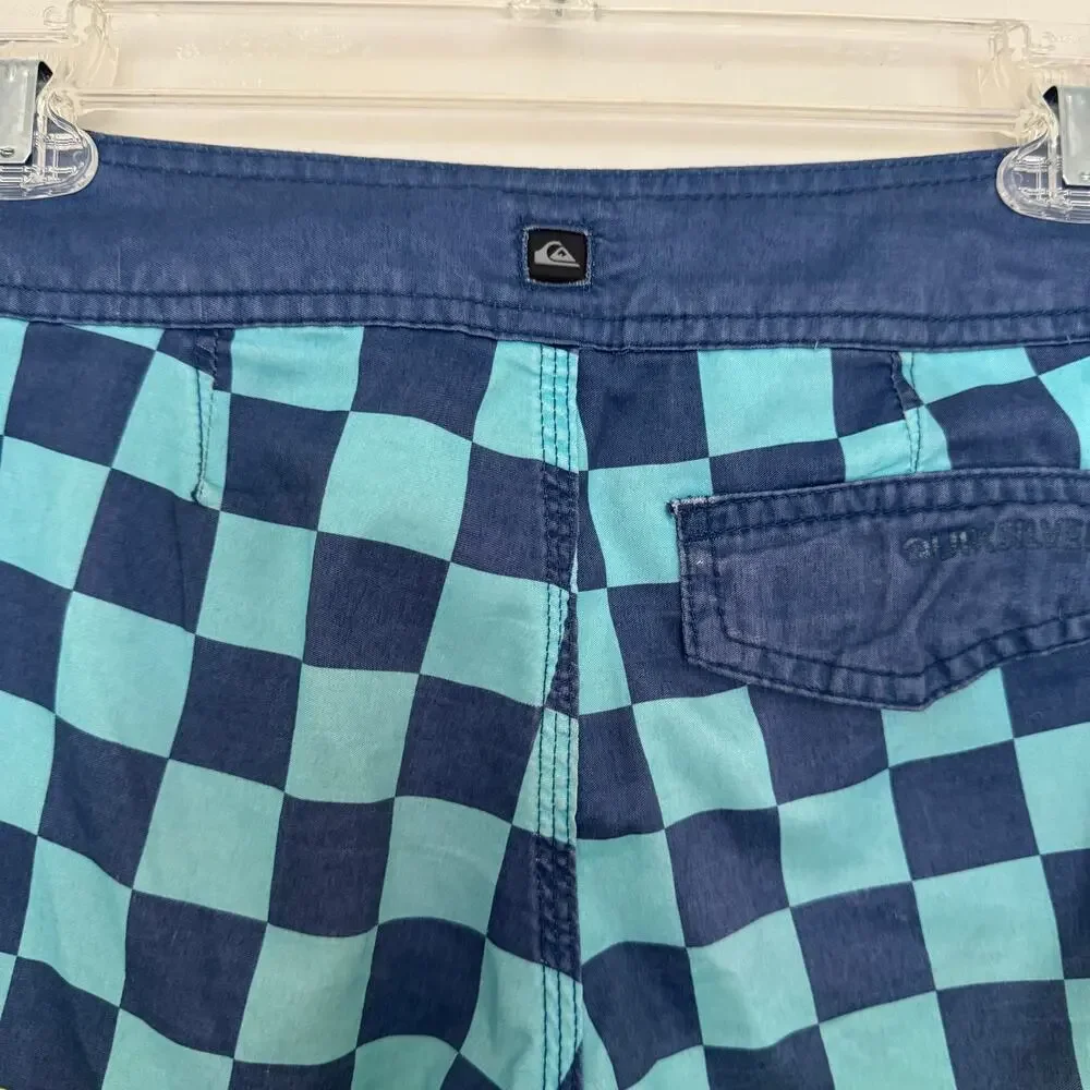 Quiksilver Board Shorts Featuring a Checkerboard Top and a Gradient Bottom
